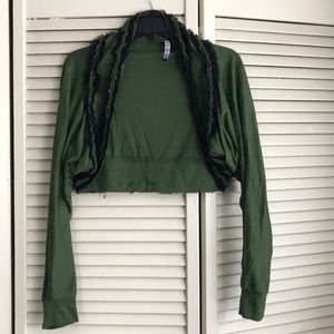 Green shrug with frilly black accents
